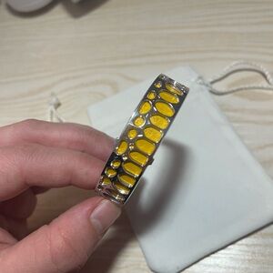 Les Georgettes silver bracelet about 14mm wide. Changeable interior strap